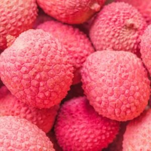 Vibrant close-up of ripe red lychee fruits showcasing their textured skin.
